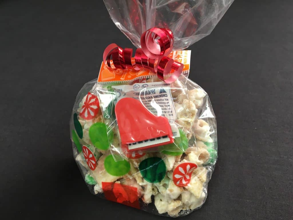 Individual bag of puppy chow with a red piano japanese eraser attached